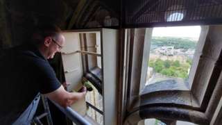 Durham Cathedral's joiner, Terry Orton, fixing a swift box into place