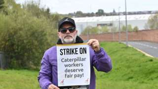 Employees and Unite union members picket at the Caterpillar site in west Belfast in April 2022