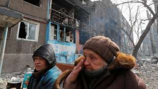 Local residents seek refuge in the basement of a damaged apartment in the besieged southern port city of Mariupol, Ukraine March 25, 2022