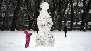 Child and a snowman