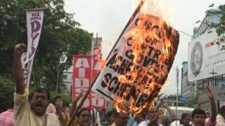 All India Democratic Students Organization (AIDSO) members burn placards and stage protest against Agnipath recruitment scheme for central defense forces on June 18, 2022 in Kolkata, India.
