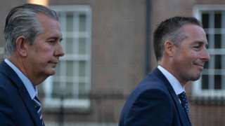 Edwin Poots and Paul Givan pictured in profile from the right hand side, both appear to be in motion