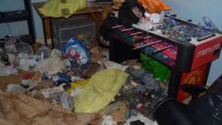 Bedroom with rubbish strewn everywhere