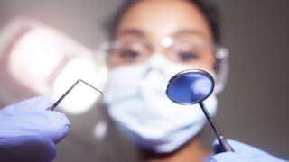 Dentist holding instruments