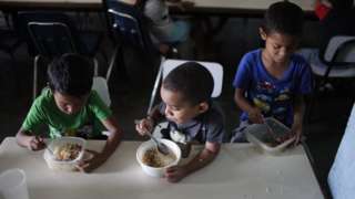 Children eat lunch at Madre Asuncion's community kitchen on October 9, 2019 in Petare, Caracas, Venezuela.