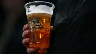 Man holding a pint of Carlsberg