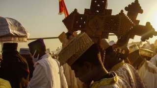 Members of Ethiopian orthodox church is seen holding Holy crosses for the high priest during the celebration of Ethiopian Epiphany in Addis Ababa Ethiopia January 18 2020.