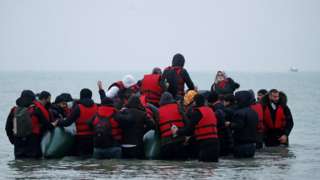 A boat is seen filled with people near Wimereux, France, on Wednesday