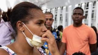 People wait for information about their missing relatives outside the Juan Pablo Pina Hospital the day after an explosion occurred in San Cristobal, Dominican Republic, 15 August 2023.