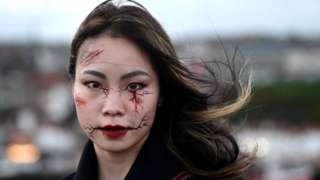 A woman poses for a photograph