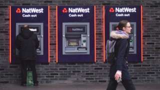 Customers using a NatWest ATM.