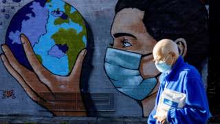A pedestrian on the Taff Trails passing the street art painted Thomas Llewelyn