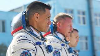 Russian cosmonauts Sergey Prokopyev (C) and Dmitri Petelin (R) and NASA astronaut Frank Rubio, members of the International Space Station (ISS) Expedition 68 main crew, report to Russia's Roscosmos space agency head prior to the launch at the Russian leased Baikonur cosmodrome in Kazakhstan on September 21, 2022