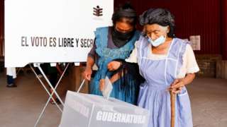 A woman casts her vote during the state elections, in Santa Maria Atzompa, in Oaxaca state, Mexico June 5, 2022.