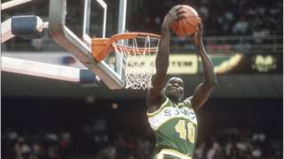 NBA All-Star Shawn Kemp dunks a basketball.
