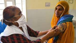 A medic administers a dose of Covaxin (COVID-19 vaccine) to a rural woman at a vaccination centre in Liri village near Beawar. Rajasthan