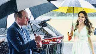 Prince and Princess of Wales in the rain