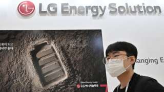 A visitor walks past a booth of LG Energy Solution at an exhibition in Seoul.