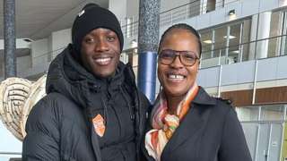 Seratiwa and Letsile Tebogo smile into the camera while standing side by side