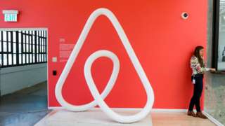 A woman talks on the phone at the Airbnb office headquarters in the SOMA district of San Francisco, California, U.S