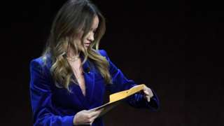 Olivia Wilde opening the letter while on stage in a theatre in Las Vegas on Tuesday