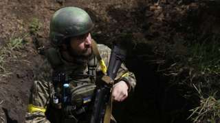 Ukrainian serviceman in a trench at a frontline area in Ruska Lozova, in Kharkiv region, Ukraine, 15 May 2022