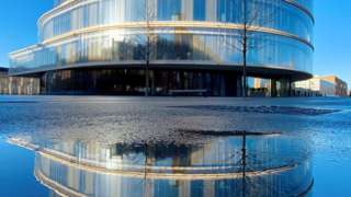 The University of Oxford's Blavatnik School of Government reflected in a puddle