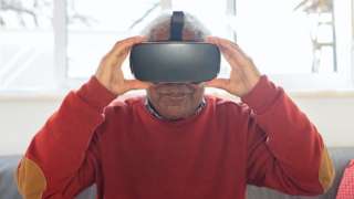 An elderly person wearing a VR headset