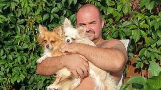 Malcolm Wright holding two dogs