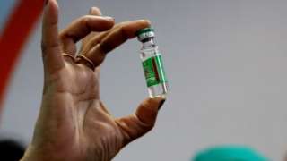 An Indian Health official displays a COVID-19 vaccine manufactured by the Serum Institute of India, at the All India Institute Of Medical Sciences (AIIMS) in Bhopal , India,16 January 2021