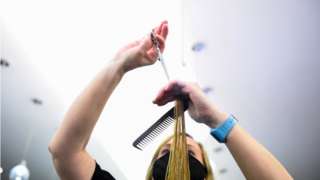 A hairdresser serves a customer at Dylan Bradshaw hair salon in Dublin