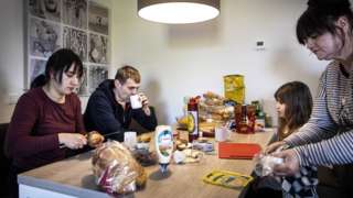 a Ukrainian family eat a meal in a home in the Netherlands
