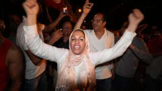 Supporters of president Kais Saied celebrate after an exit poll indicates voters backed new constitution in Tunis, Tunisia, 25 July 2022