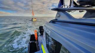 The police boat approaches the yacht