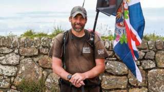 A man smiles at the camera