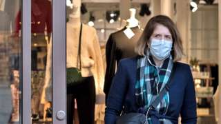 Woman in shop with face mask on