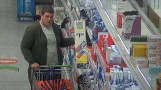 Man putting supermarket items in trolley