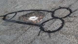 A penis around a pothole