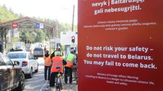 People with bicycles stand at the border crossing point Sumskas between Lithuania and Belarus on August 12, 2023