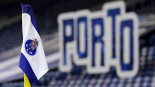 A corner flag with the Porto badge on it in front of a Porto sign inside the Estadio do Dragao during their Champions League tie against Manchester City