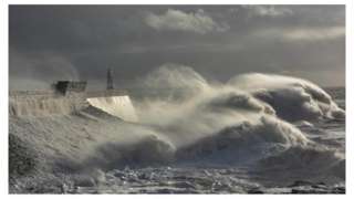 Large waves crash onto the sea wall in Porthcawl, South Wales