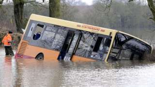 Bus trapped in flood water north of York