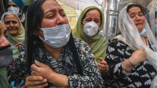 Relatives of slain government school principal Supinder Kour mourns during a funeral procession in Srinagar on October 8, 2021, a day after suspected anti-India militants shot dead two school teachers in Indian-administered Kashmir.