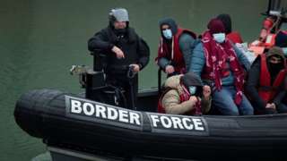 A UK Border Force patrol boat carries migrants picked up at sea on arrival at the Marina in Dover