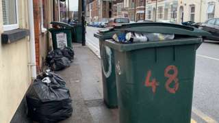 Overflowing bins and dumped rubbish