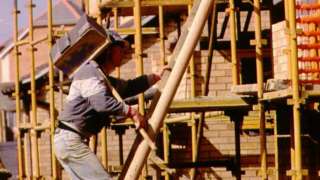 Man carrying hod on building site
