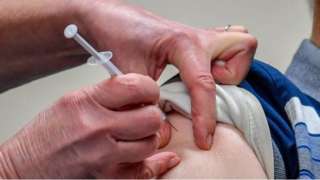 Covid-19 vaccine being given to top of the arm