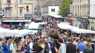 People crowd around market stalls in Frome