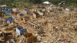 A view shows debris of houses and other buildings that were destroyed when a vehicle carrying mining explosives detonated along a road in Apiate, Ghana, January 21, 2022