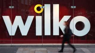 A person walks past a Wilko store